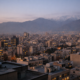 The City With the Most Bank Branches on Earth Is Tehran 1 A wide aerial view of central Tehran at dusk showing dense urban blocks and high-rise office towers in the financial district