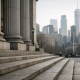 A courthouse facade and a distant city financial skyline representing a high-profile cross-border fraud case