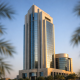 A modern bank tower in the United Arab Emirates seen against a clear sky, representing central bank monetary policy