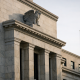 Fed Publishes OppFi Bank-Holding-Co Application in Federal Register 1 The marble facade of a Federal Reserve building under a clear sky, symbolising formal banking regulatory review