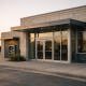 A regional bank branch facade in Texas at dawn, ahead of a quarterly earnings release
