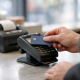 A shopper at a checkout terminal in the United Kingdom completing a buy now pay later payment