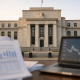 US Federal Reserve building with financial data screens showing inflation figures