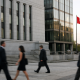 Exterior of a Canadian central bank building with national flag under natural daylight