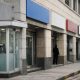 A row of Indian public sector bank branch signs on a city street with an ATM vestibule visible