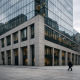 A bank headquarters facade in a Swiss financial district under overcast daylight