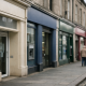 A row of UK high street bank branches with savings account signage in daylight