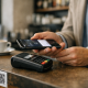 Wero Digital Wallet Goes Live in Luxembourg, Replacing Payconiq 2 A smartphone displaying a mobile payment app at a Luxembourg cafe counter