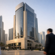 Facade of a bank tower in a Gulf financial district under natural daylight