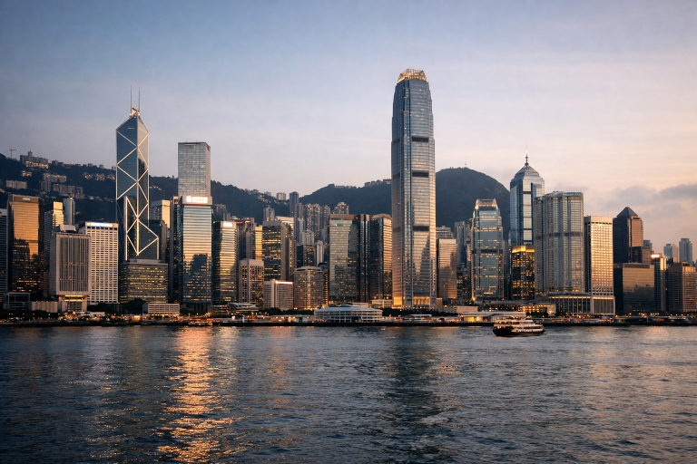 Hong Kong skyline and financial district seen across Victoria Harbour, illustrating a cross-border asset management deal