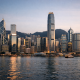 Hong Kong skyline and financial district seen across Victoria Harbour, illustrating a cross-border asset management deal