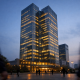 A large Chinese state bank headquarters tower in Beijing seen from street level at dusk