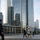 Exterior of a modern bank headquarters tower in Frankfurt's financial district under soft morning light