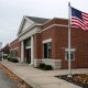 Exterior of a small American community bank branch on a quiet main street in rural Ohio